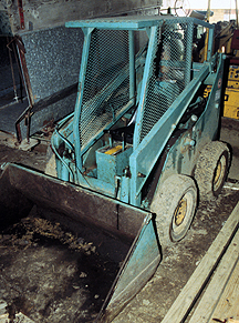 Photo 1:  skid-steer loader with lowered bucket