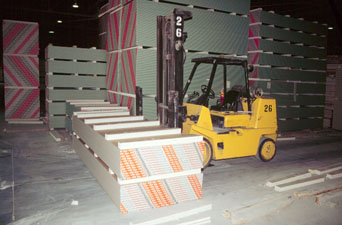 photo of forklift next to stack of drywall