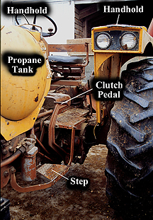 Photo 1: tractor with captions indicating handholds, propane tank, clutch pedal and step