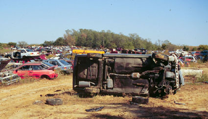 photo of wrecked car in salvage lot
