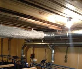 Newly installed duct work recirculating clean air in a farrowing barn. 
