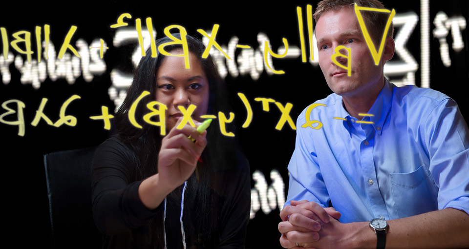 Prof. Patrick Breheny and a student go over some equations.