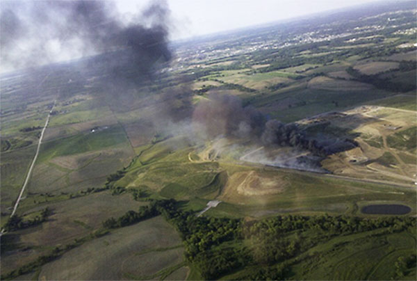 An aerial view of the 2012 Iowa City landfill fire, with smoke primarily from the burning shredded tire drainage layer.