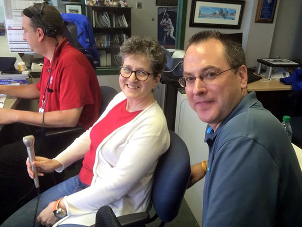 photo of Laurie Gutmann and Chris Coffey in the Iowa Cubs broadcast booth.