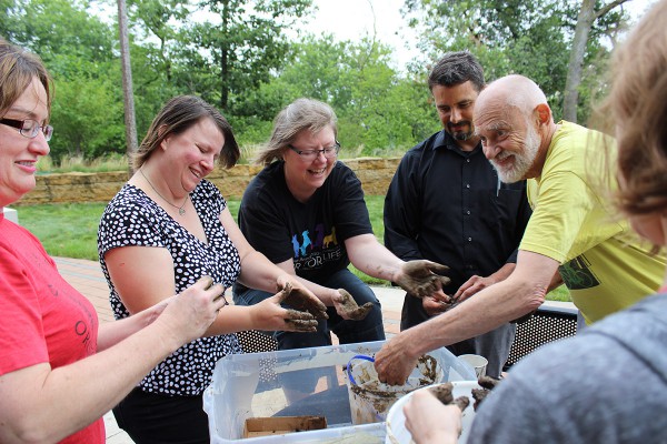 volunteers making milkweed 'seed bombs' for Monarch butterfiles