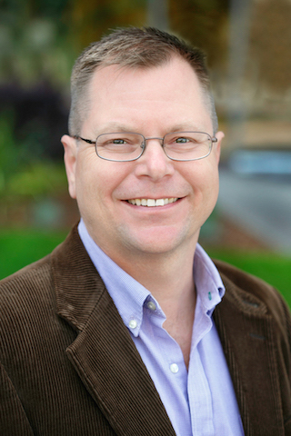 A portrait of Paul Gilbert, assistant professor of community and behavioral health at the University of Iowa College of Public Health.