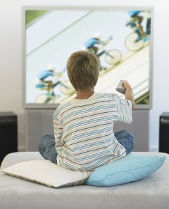 Boy sitting in living room watching television