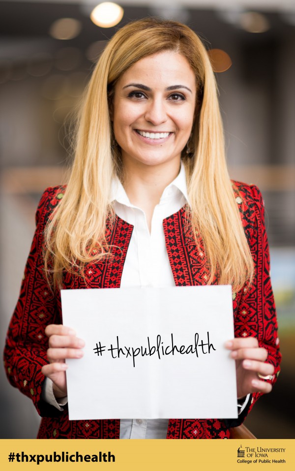 portrait of alumna Tala Al-Rousan holding a sign that reads Thanks Public Health