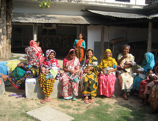 Women with their infants sitting outside in Bangladesh