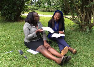 Two research assistants conduct a mock interview using the HIV patient satisfaction survey instrument.