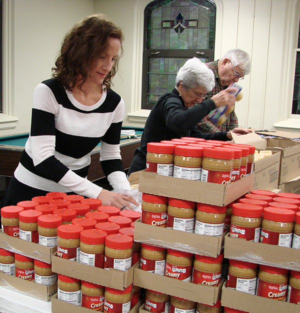 Volunteers prepare food for Carry On Bags