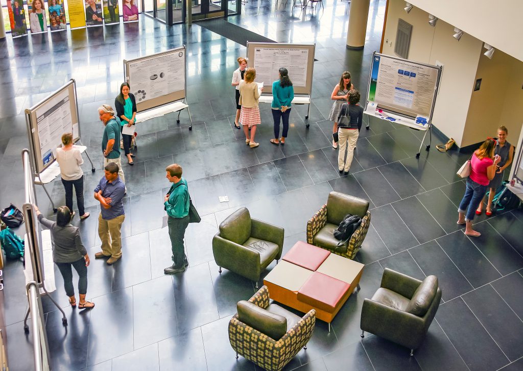 students presenting posters in the CPHB atrium