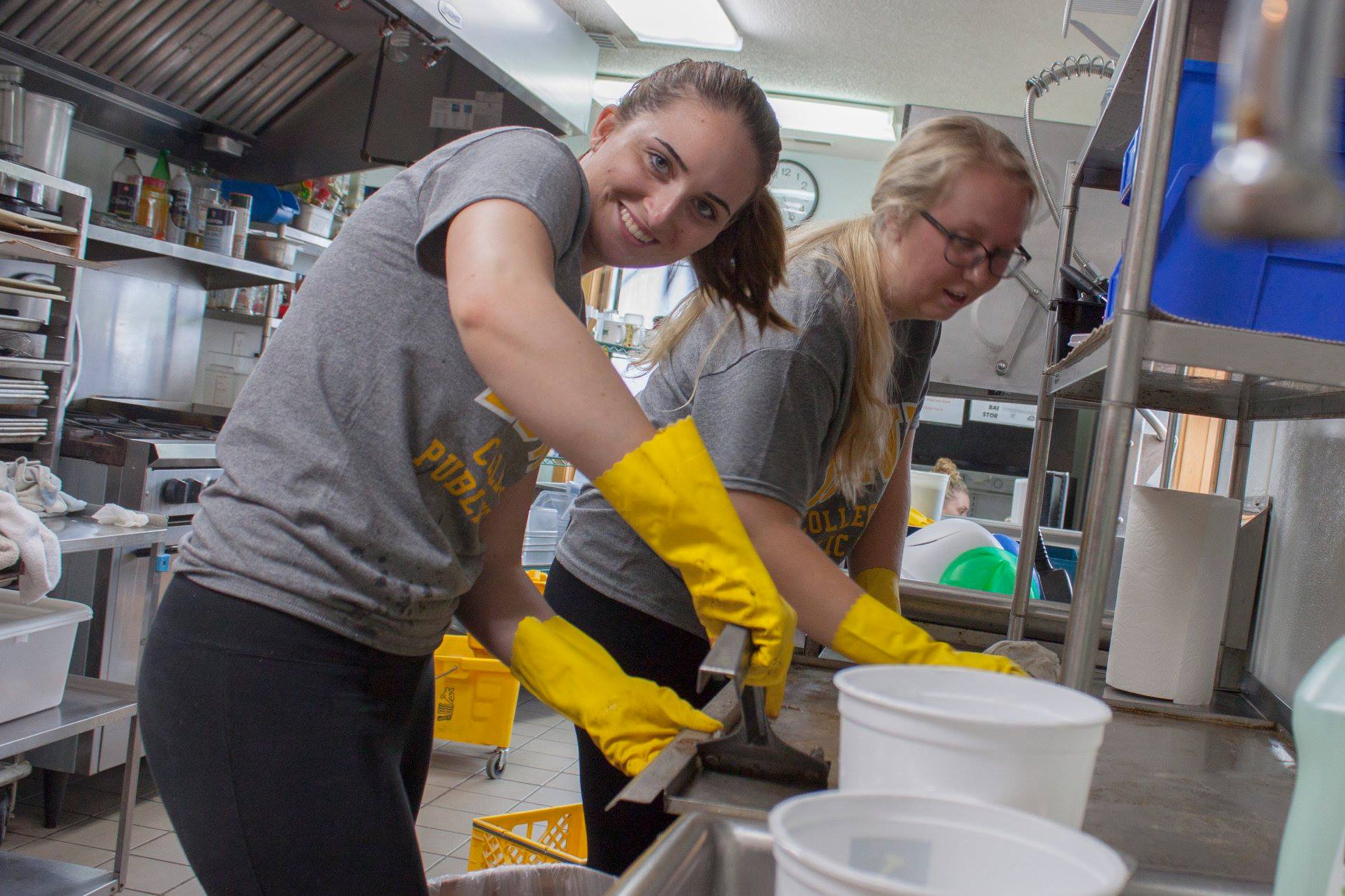 Students help clean the kitchens at the Neighborhood Centers of Johnson County as part of the University of Iowa College of Public Health's annual Day of Service.
