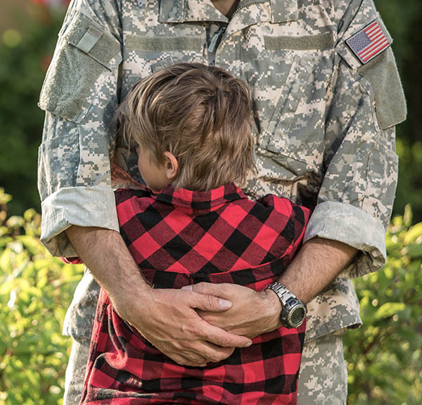 a soldier hugging his child