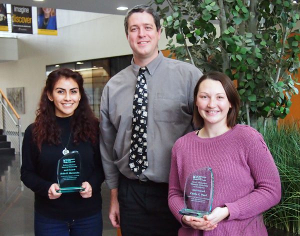 Graduate students Helin Hernandez (left) and Caitlin Ward (right) with Professor Jake Oleson