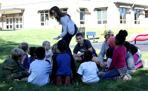 Elementary age kids play a tag game