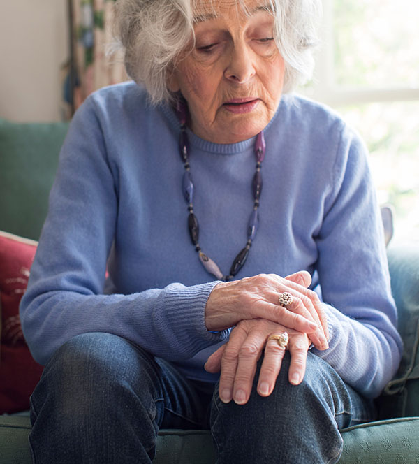 older adult woman sitting in chair