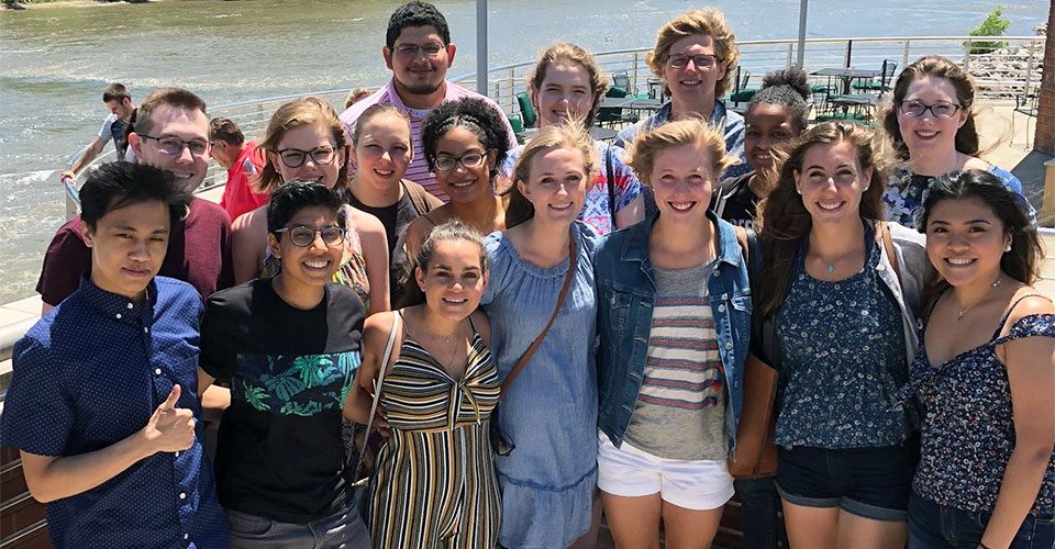 Students at the Iowa Summer Institute in Biostatistics pose in front of the Iowa River.