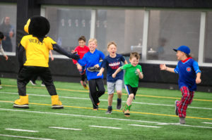 Healthy LifeStars kids playing with Herky the Hawk mascot