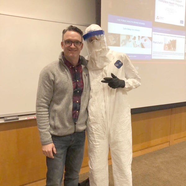 CPH Prof. Matt Nonnenmann poses with a student dressed in a hazmat suit.