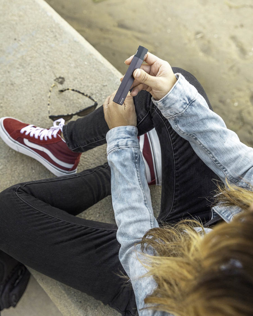 photo of teen holding a vaping device