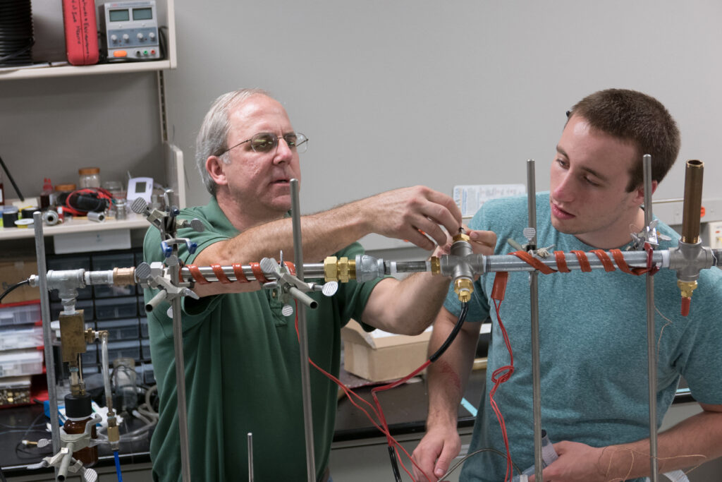 Prof. Patrick O'Shaughnessy assists a student in the lab