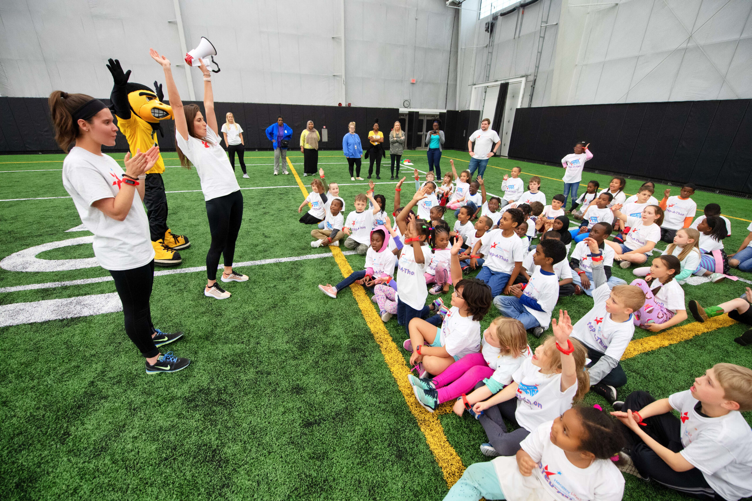 Students, Herky the Hawk, and coaches participate in a Healthy LifeStars event