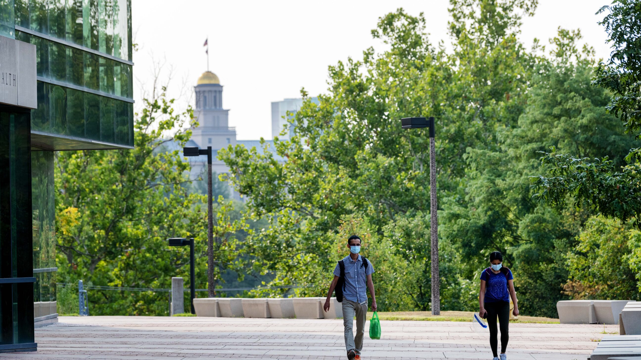 Students walking past the College of Public Health Building on their way to class.