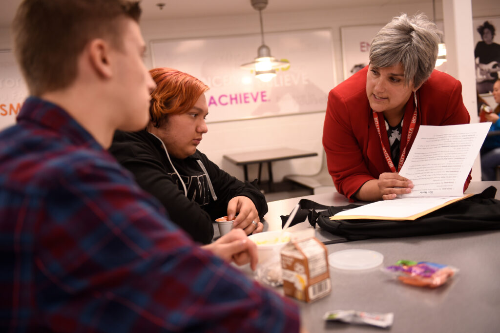 Prof. Natoshia Askelson talks with young people as part of a research project.