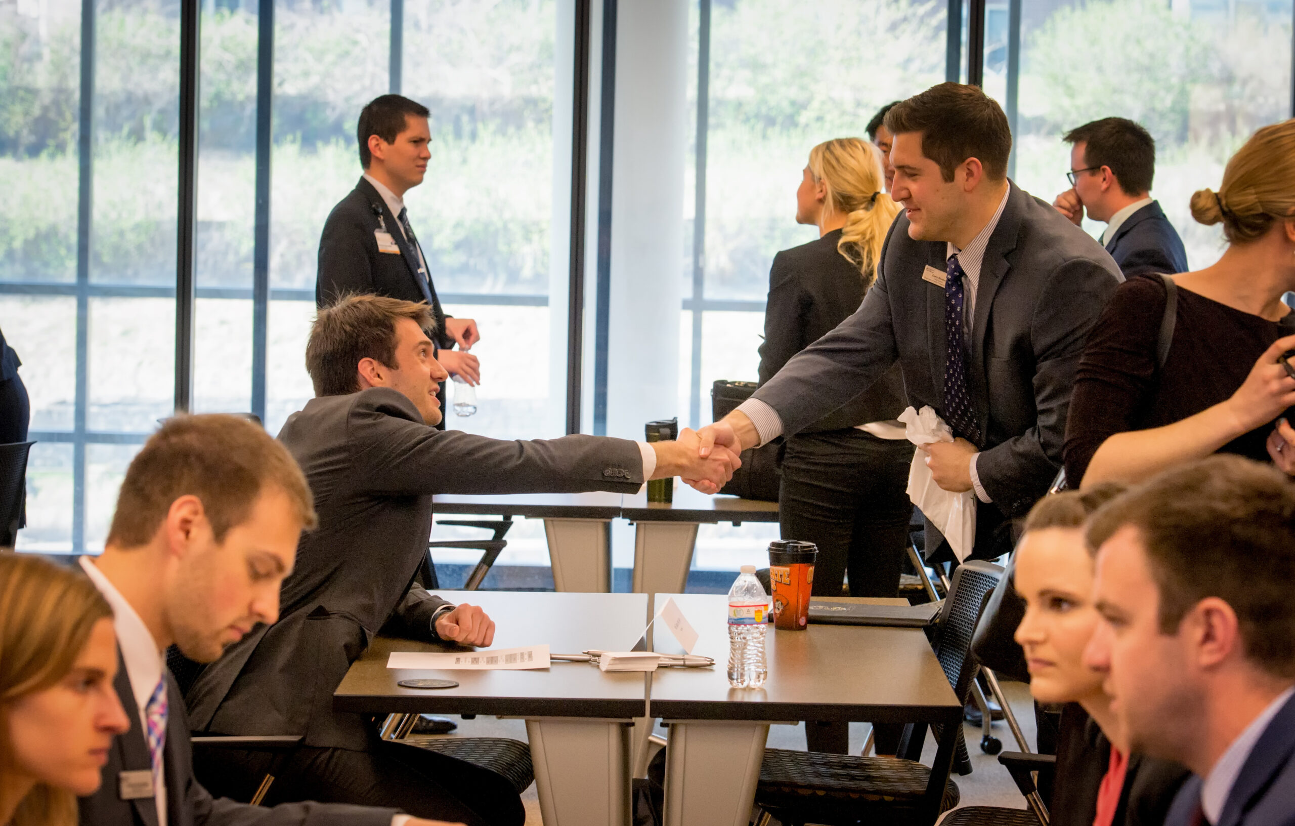 CPH student shaking hands across a table