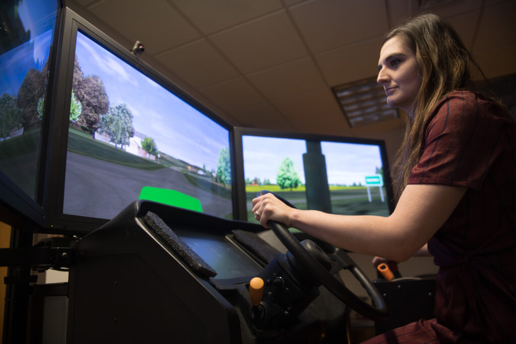 Occupational and Environmental Health PhD student, Kayla Faust, from Manchester, Iowa, examines driving performance using a new, PC-based tractor driving simulator to understand the factors that contribute to crash risks among farm equipment operators, which can also have important implications for driver safety in general since many tractor-involved crashes occur on public roadways and have severe outcomes.