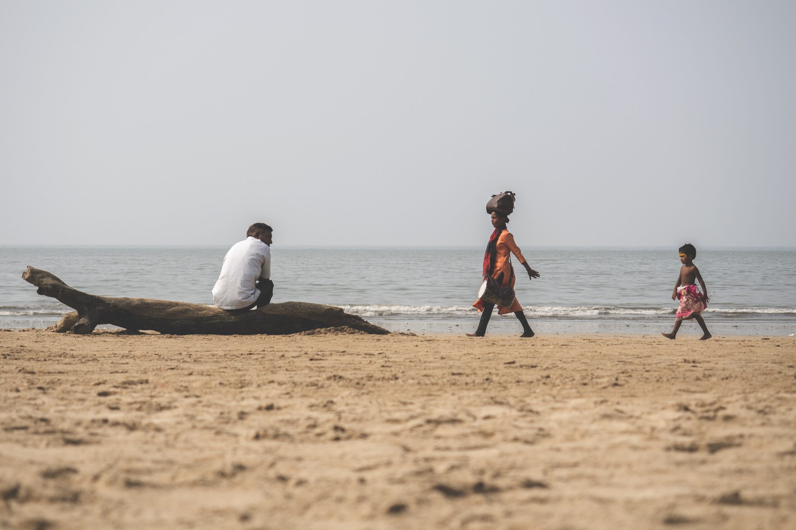 People walking along beach in India