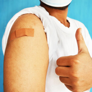Man getting vaccinated with shot in his shoulder