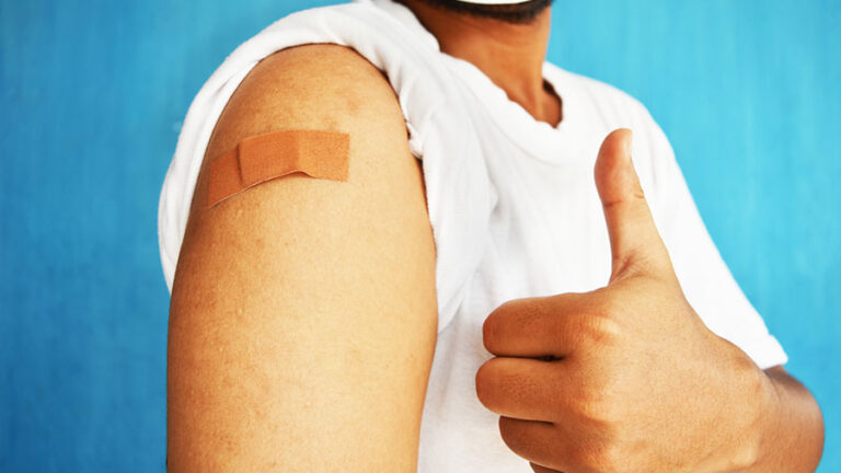 man giving a thumbs up after receiving vaccine