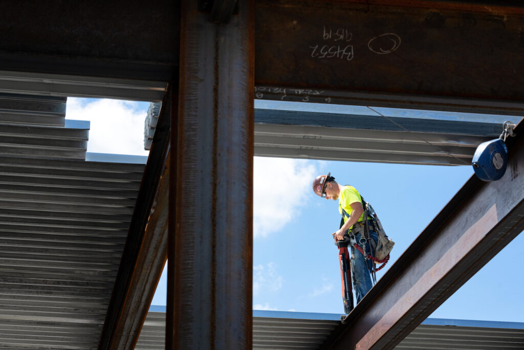 A construction worker working on the roof of the new UI Art Museum