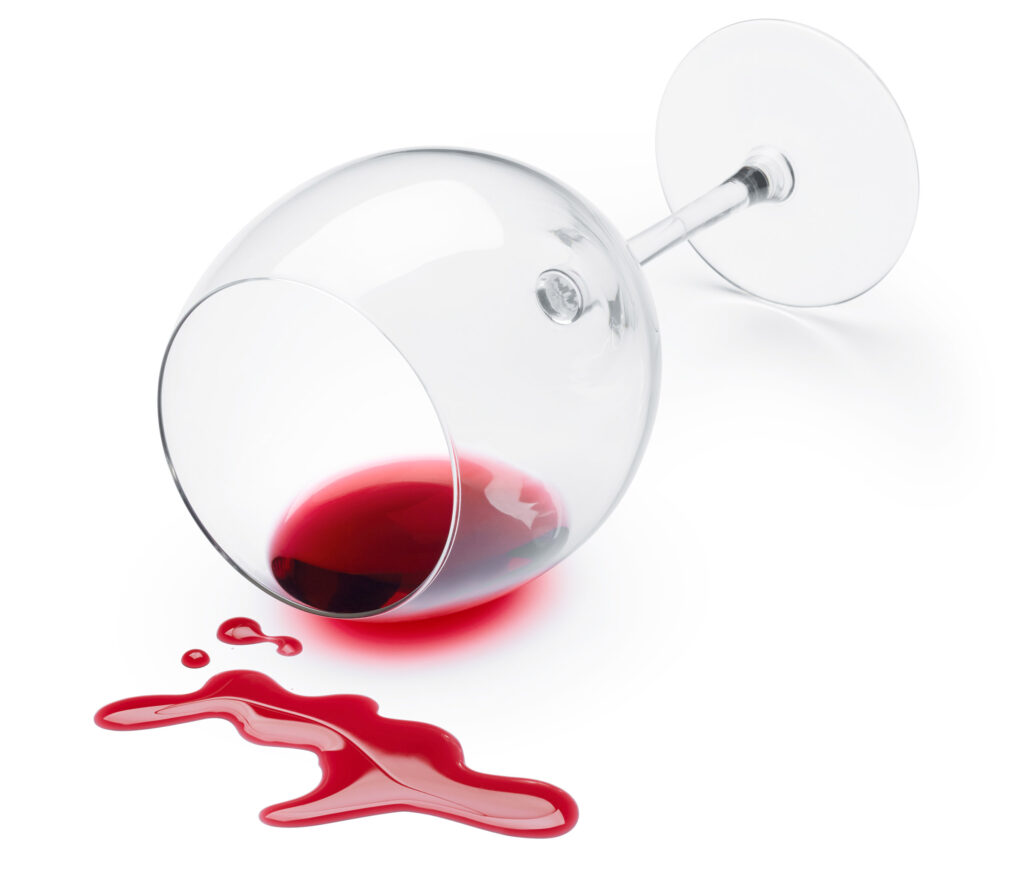 red wine spills from a glass