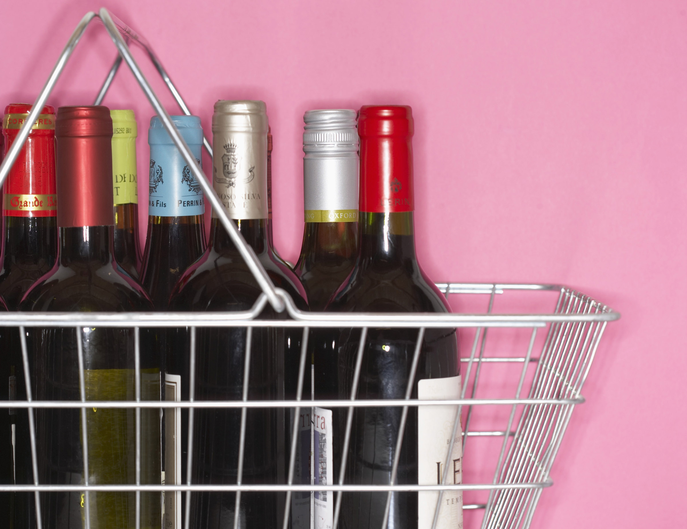 A shopping basket filled with bottles of wine