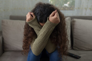 unhappy girl on a sofa