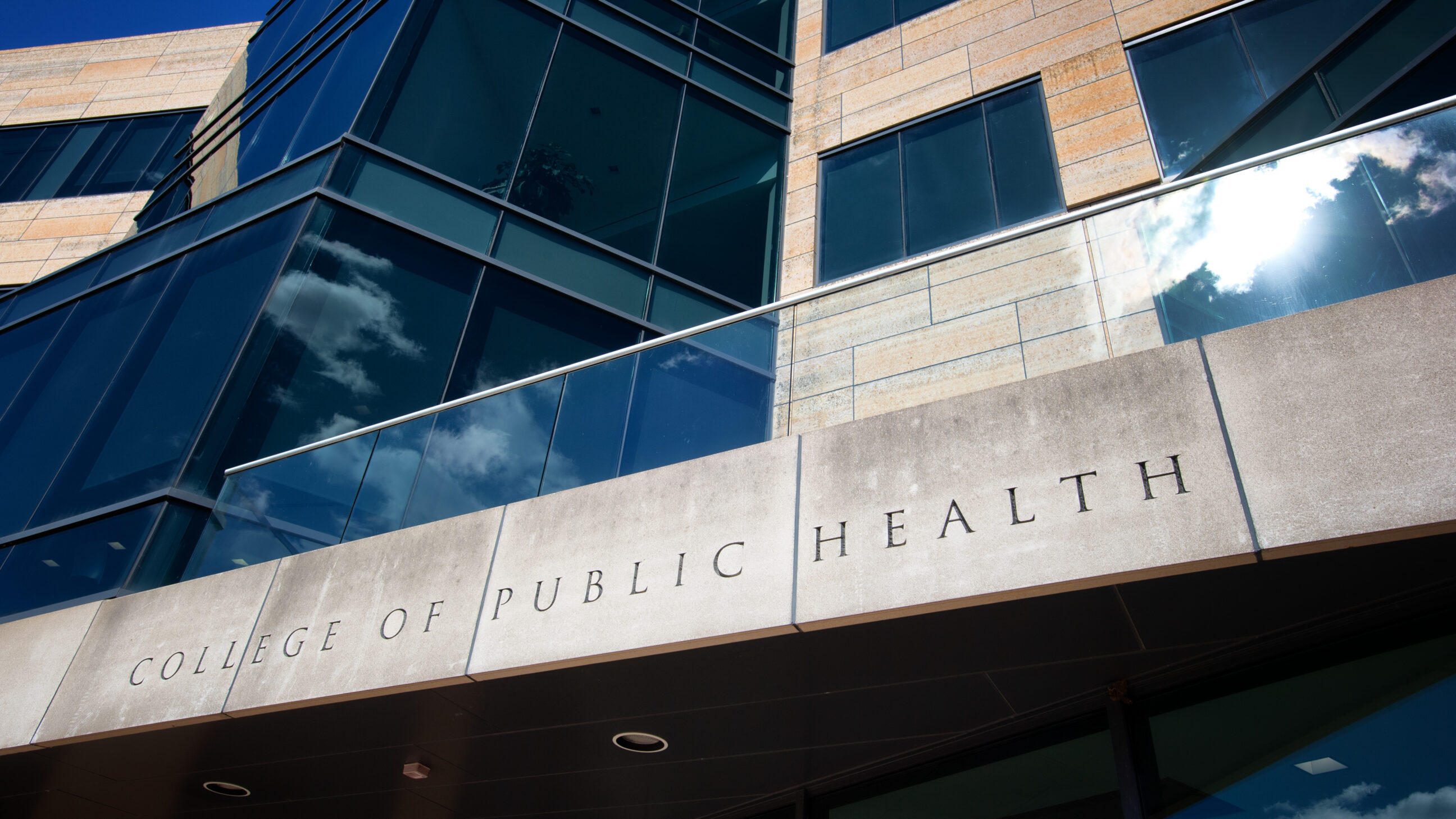 The "College of Public Health" sign, etched in stone, above the south entrance to the College of Public Health Building.