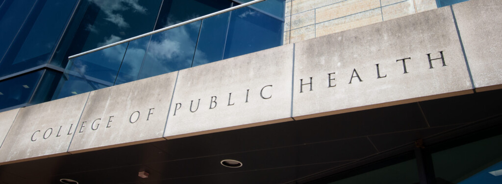 The "College of Public Health" sign, etched in stone, above the south entrance to the College of Public Health Building.