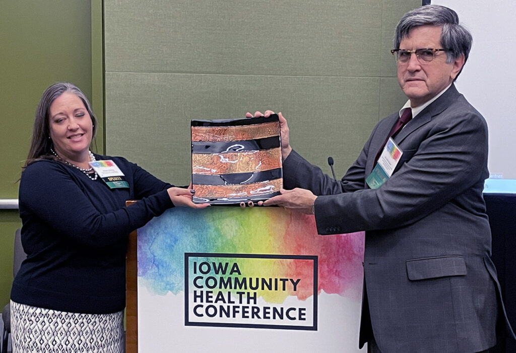 Professor Keith Mueller receives the 2021 Jerry Karbeling Award from IRHA Board President Megan Hartwig.