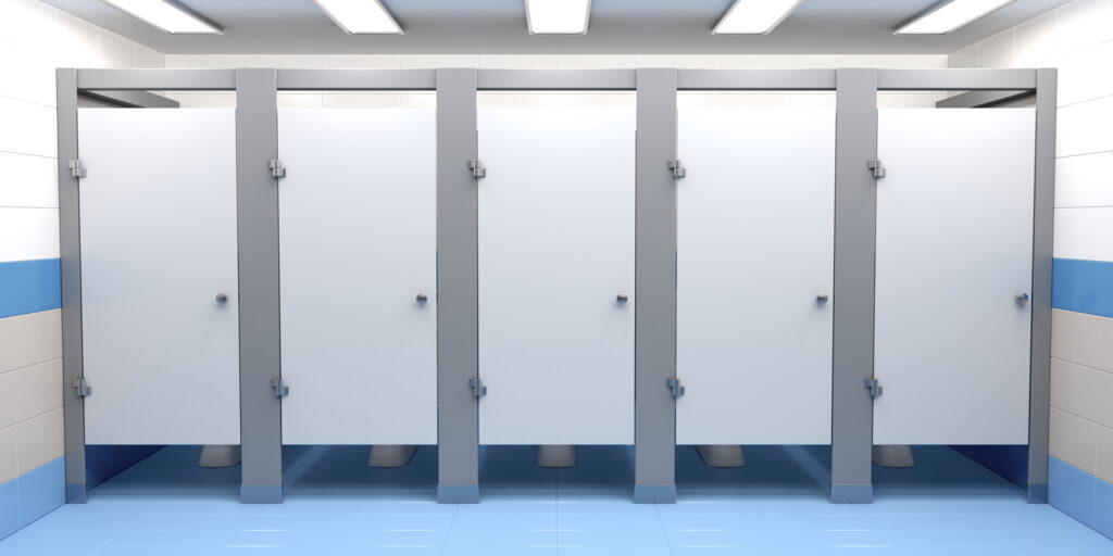 Row of toilet stalls in public restroom