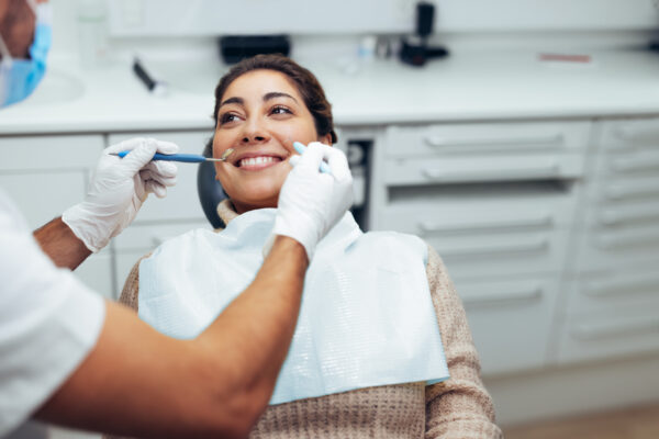 Dentist examining a female patient's teeth