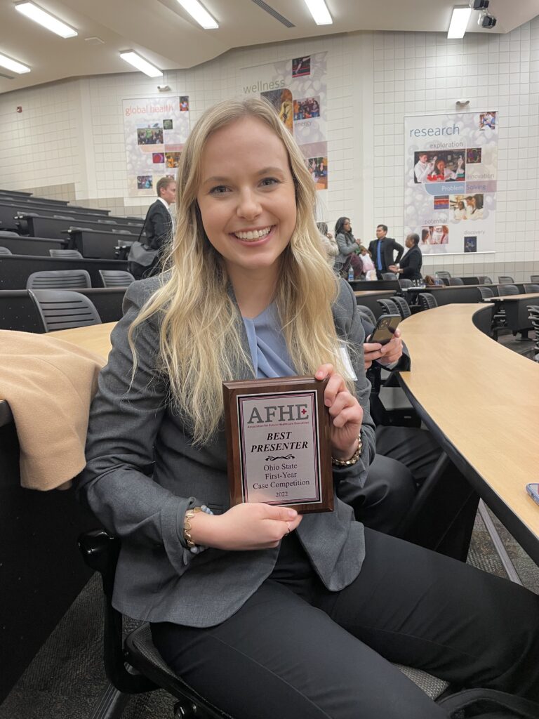 Maddie Huinker poses with the "best presenter" award