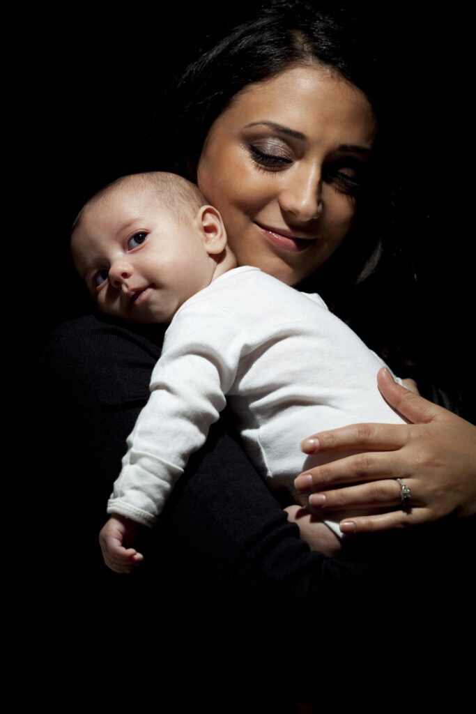 a young woman holding a baby