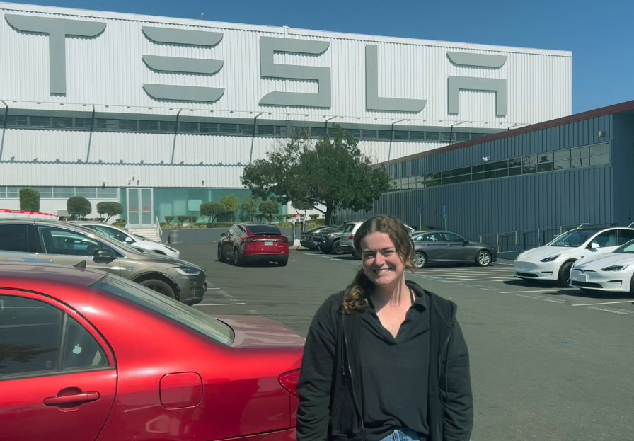 Lauren Barlow standing in front of the Tesla sign in Fremont, California