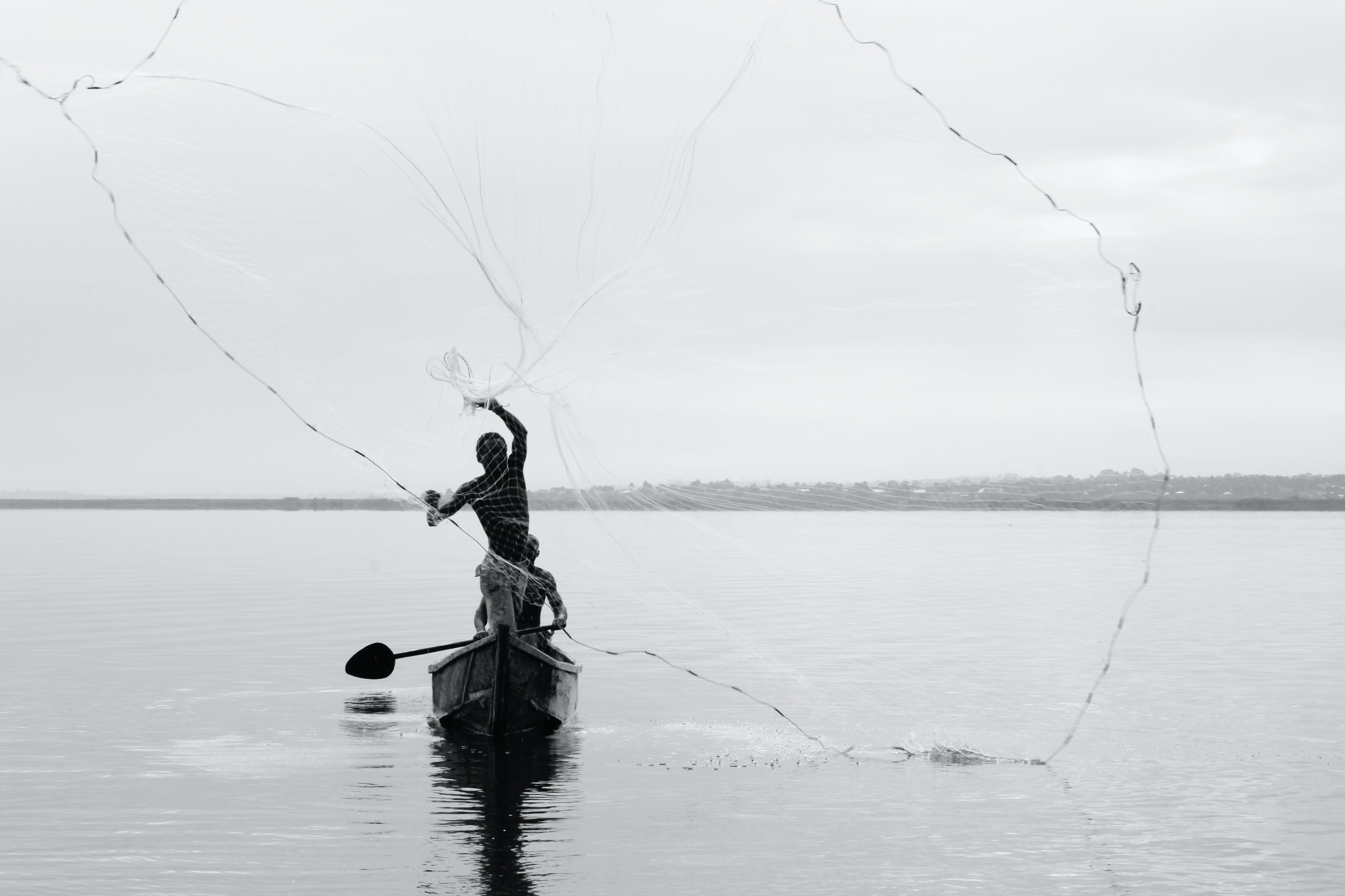 Man casting a fishing net on Lake Victoria
