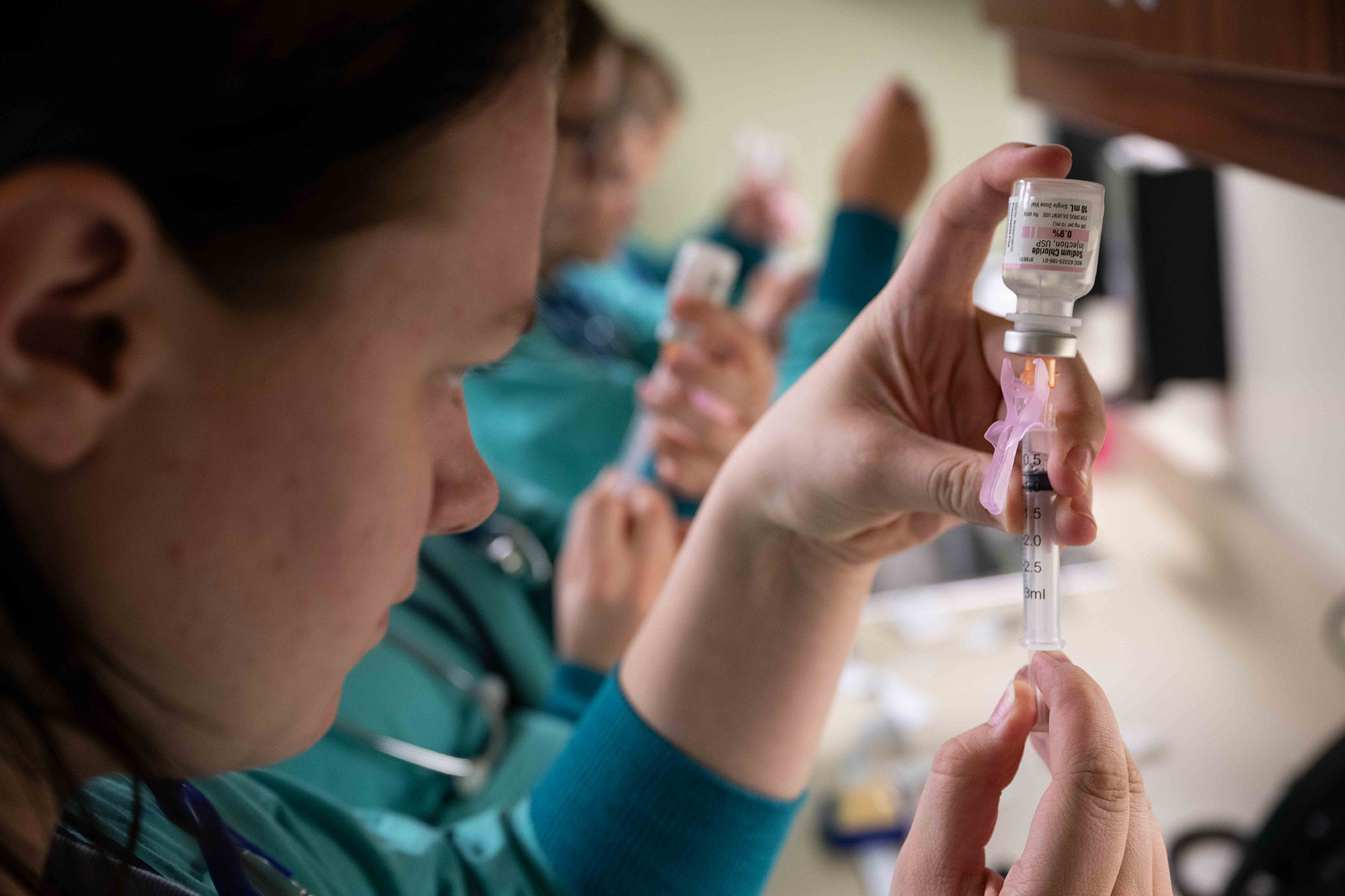 a student fills a syringe at a health careers camp in Manning, Iowa funded by the BLN