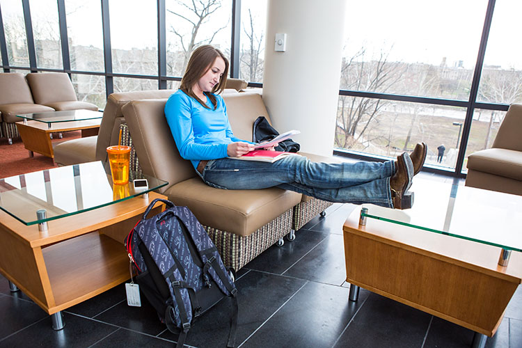 A student studying in the student commons of CPHB