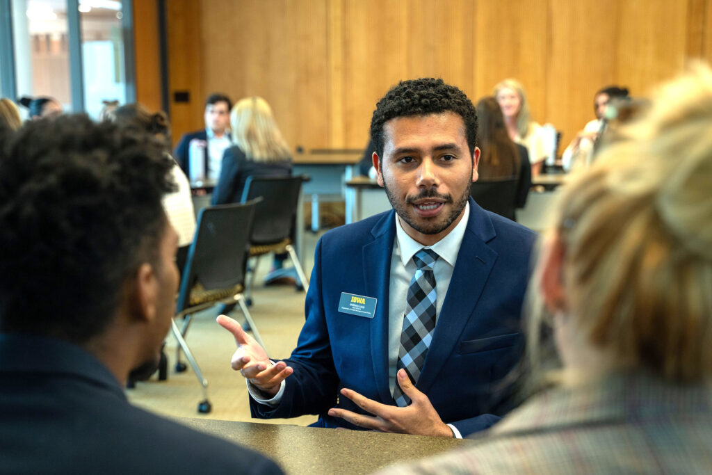 A College of Public Health graduate student speaks at a networking event.